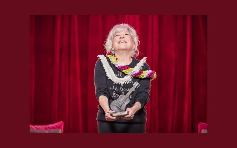 Bette Midler holds the 2026 Woody Guthrie Prize at Cain’s Ballroom in Tulsa.
