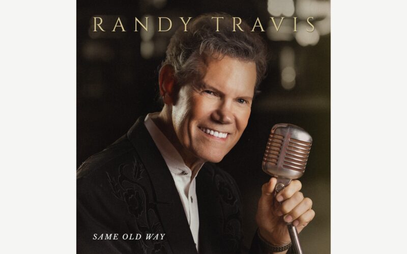 Randy Travis holding a vintage microphone on the Same Old Way album cover.